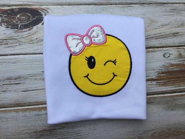 Emoji bow wink face shirt or onesie.